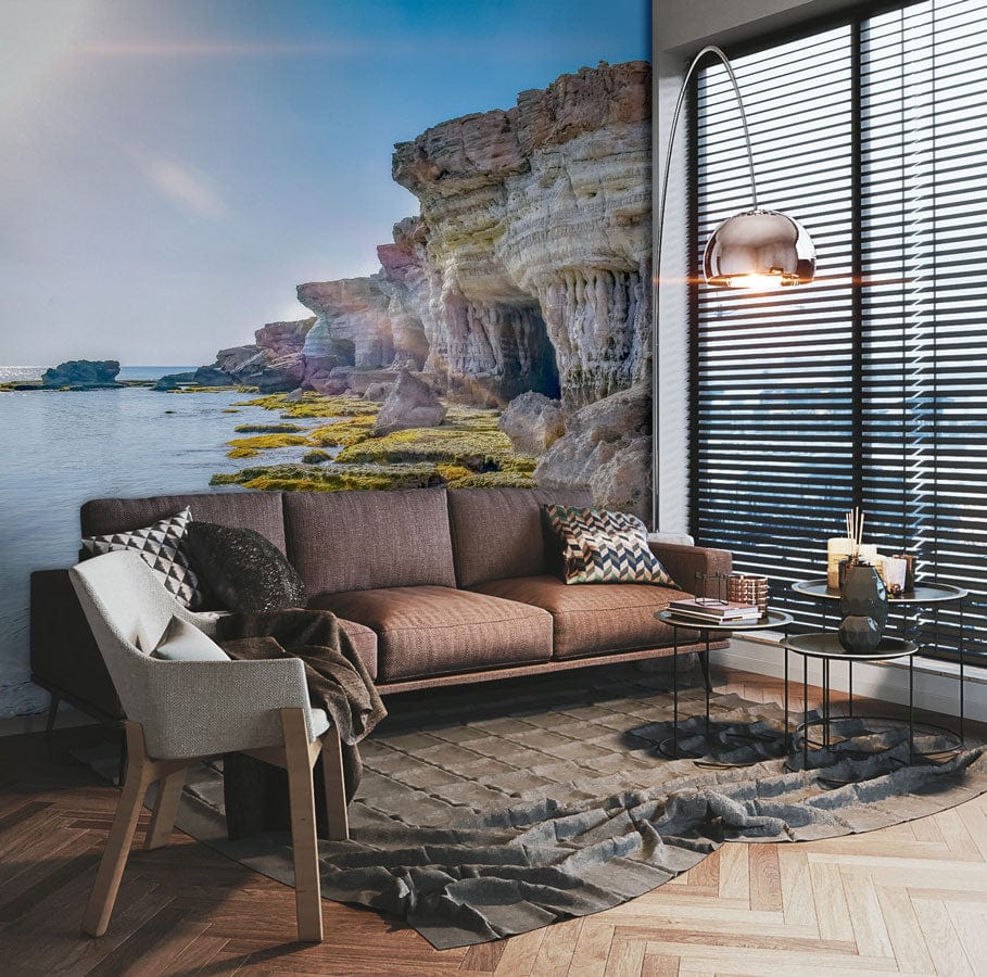 Coastal Cliff Serenity Mural, tranquil seaside scene with brown sofa, grey armchair, wooden flooring.