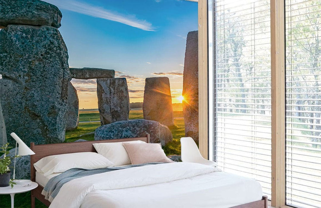 Sunlit Stonehenge Scenic Mural Wallpaper in modern bedroom with wooden accents and white bedding.