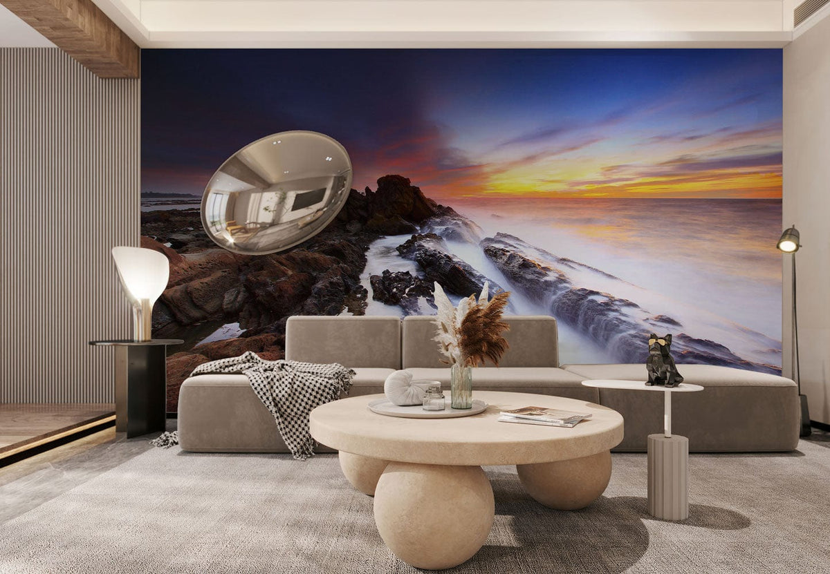 Sunset Seascape Mural Wallpaper in living room with grey sofa, modern lighting, and round coffee table.