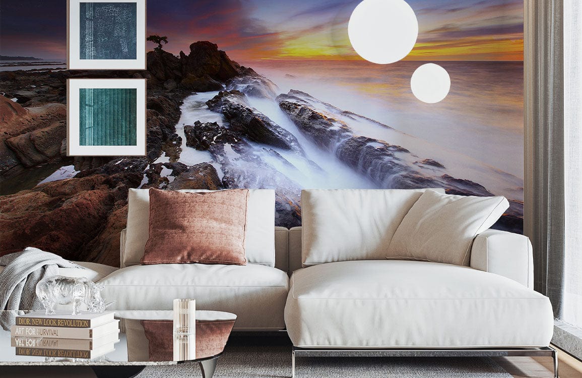 Sunset Seascape Mural on lounge wall with cream sofa, wooden flooring, and abstract framed art.