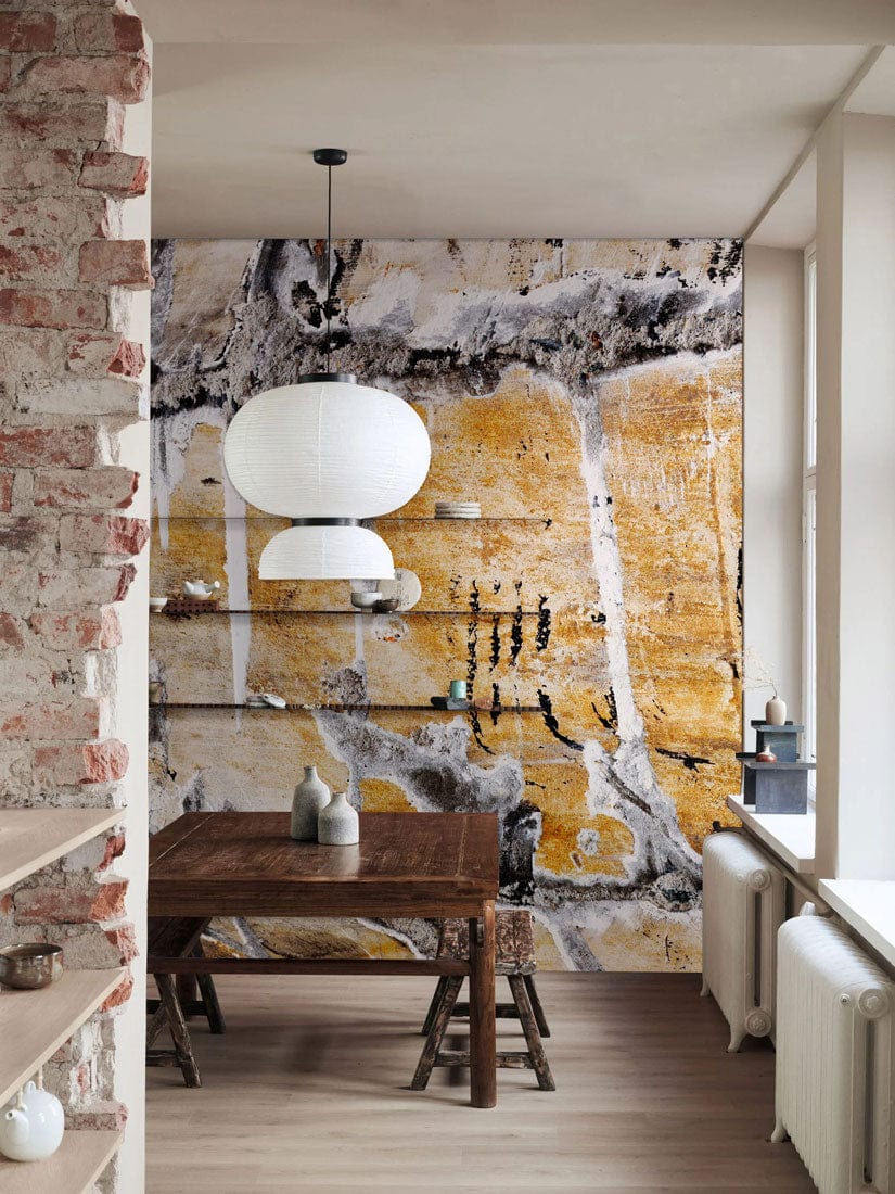 Rustic Earth Tones Abstract Stone Mural Wallpaper in dining room with wooden table and modern lighting.