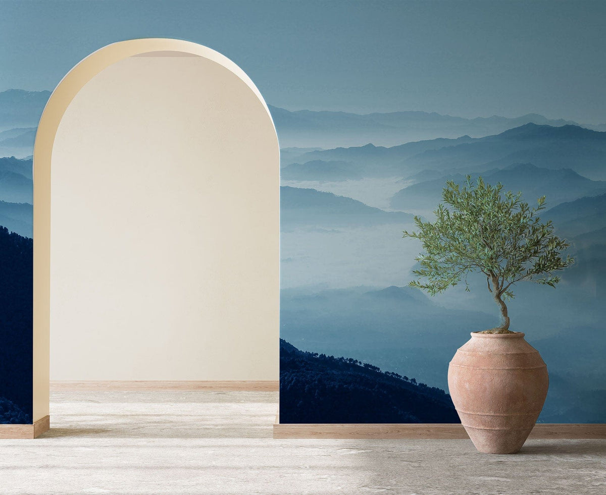 Arched doorway with Tranquil Blue Misty Mountains Wallpaper; terracotta vase; minimalist style room.
