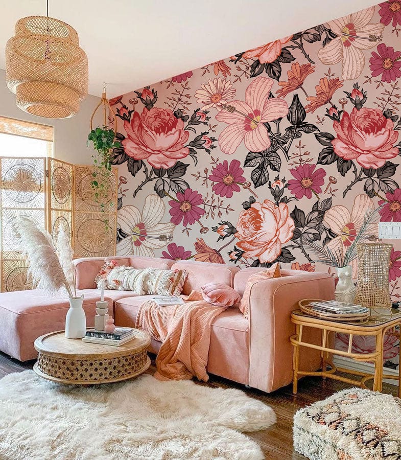 Vintage floral wallpaper with pink roses, beige sofa, wicker furniture, and wooden flooring in living room.