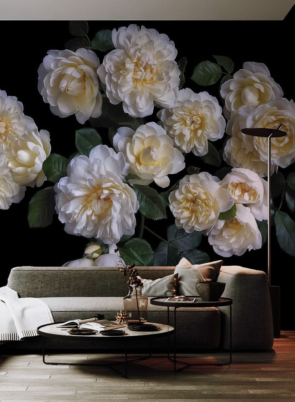 Elegant cream roses on black floral wallpaper, grey sofa, wooden flooring, modern floor lamp, cosy room.