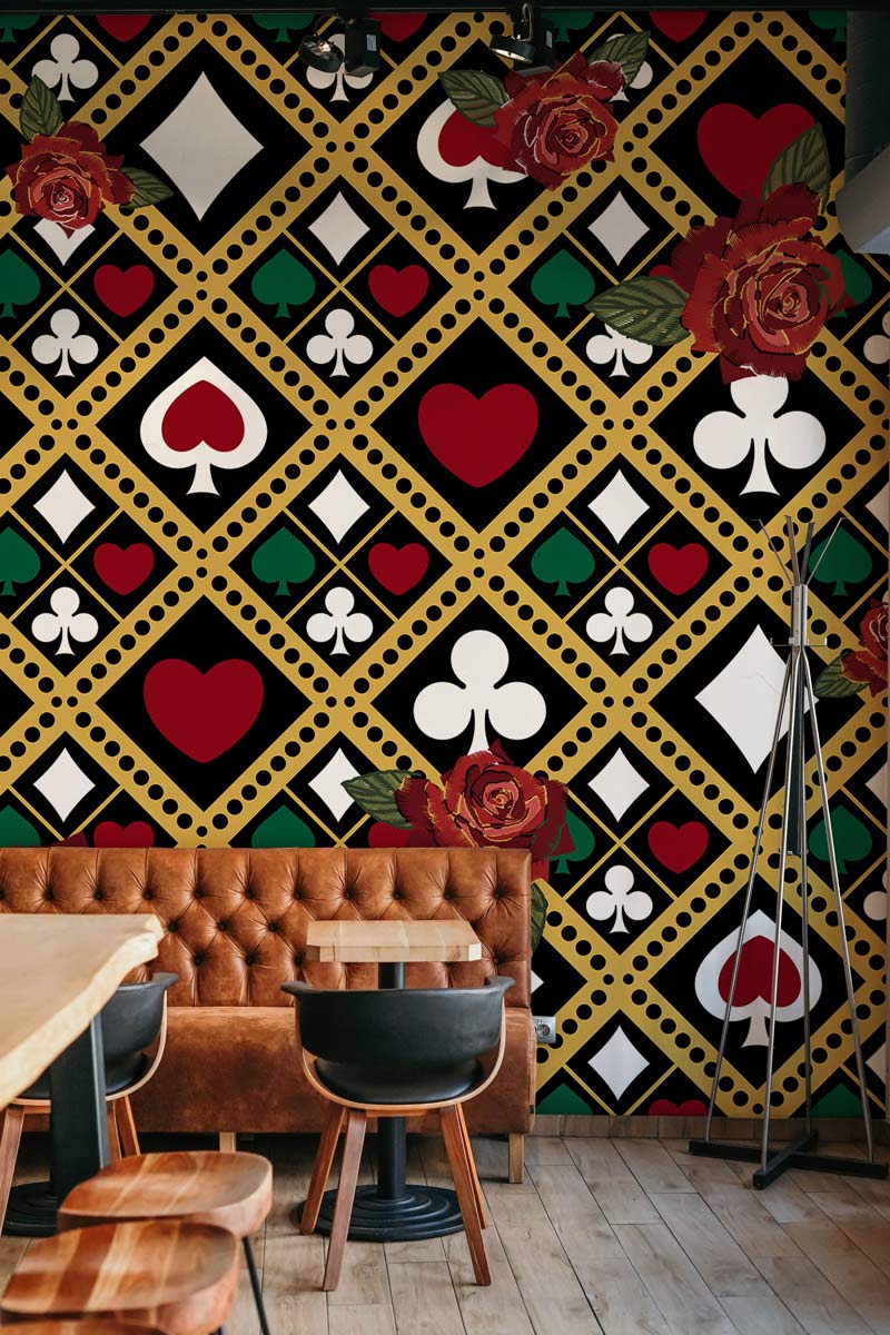 Vintage Card Suit Pattern Wallpaper with red rose accents, brown leather sofa, wooden flooring, modern café.