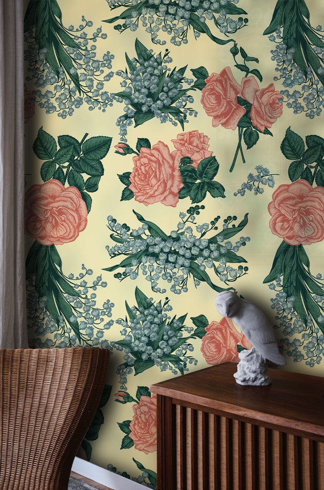 Vintage floral blossom wallpaper, soft pink and green, wicker chair, wooden cabinet, elegant decor.