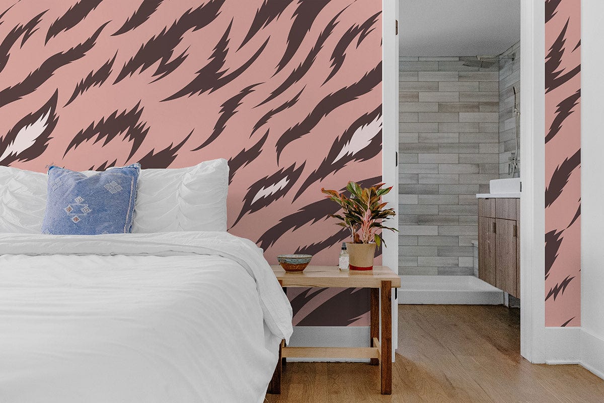 Elegant pink and brown tiger print wallpaper in bedroom with white bed, wooden flooring, bathroom view.