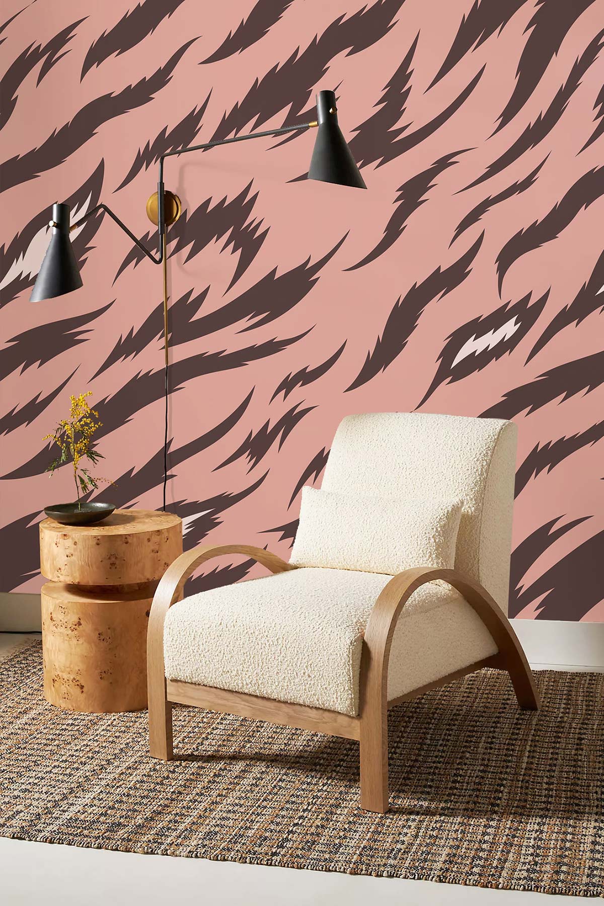Elegant pink and brown tiger pattern wallpaper, beige armchair, modern lamp, round wooden table, rug.