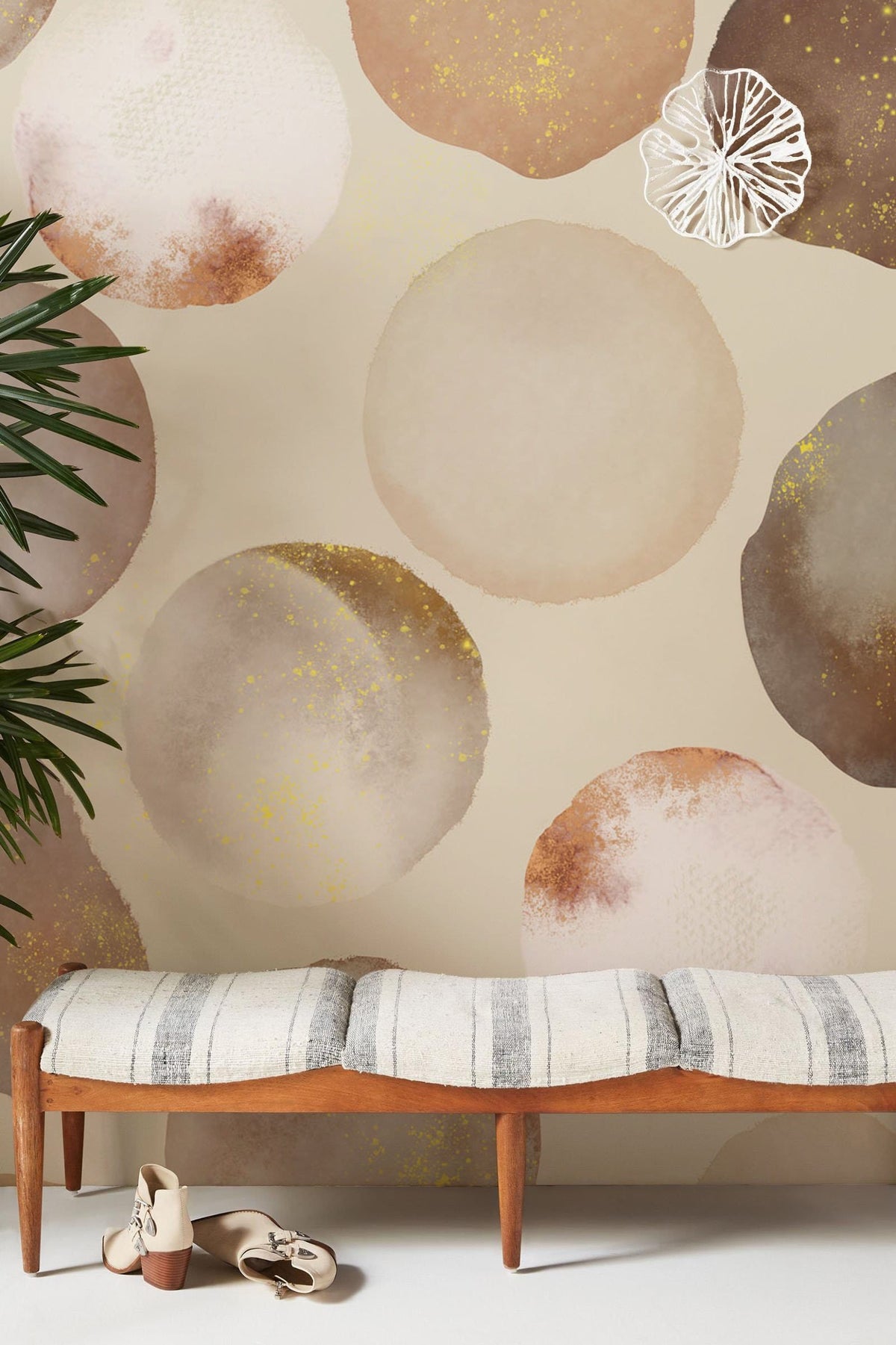 Elegant watercolour circles wallpaper in room with bench, striped cushion, neutral tones, abstract design.