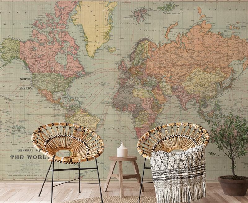 Vintage world map mural in earthy tones, with wicker chairs and light wood flooring in living room.