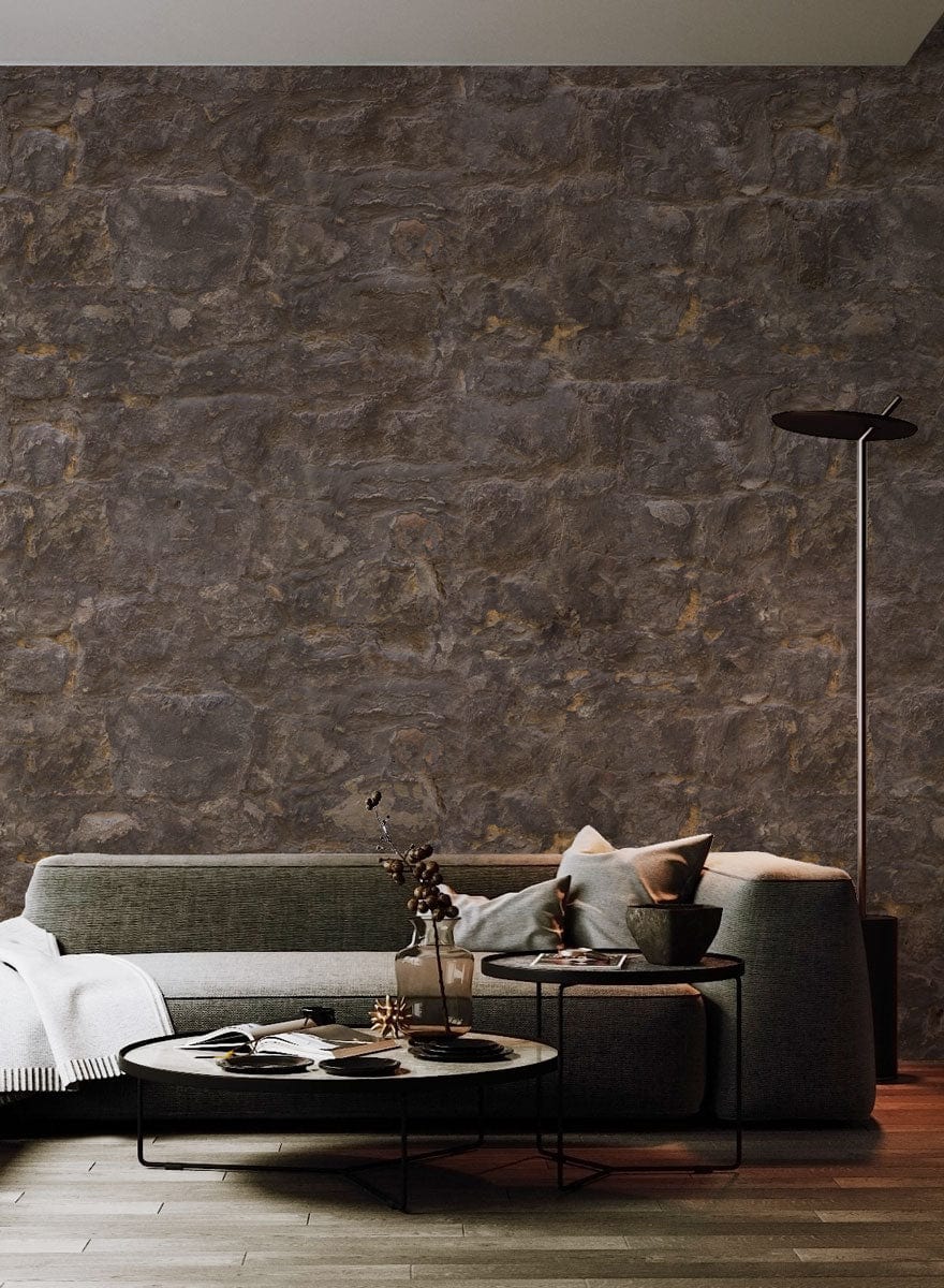Rustic brown stone wallpaper in living room, grey sofa, wood flooring, modern floor lamp.