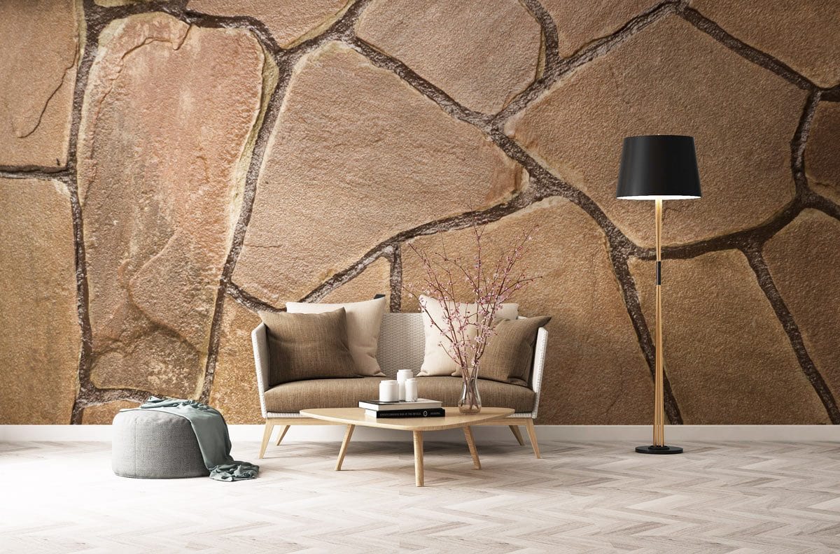 Rustic stone effect wallpaper with earthy tones, beige sofa, parquet flooring, black floor lamp in living room.