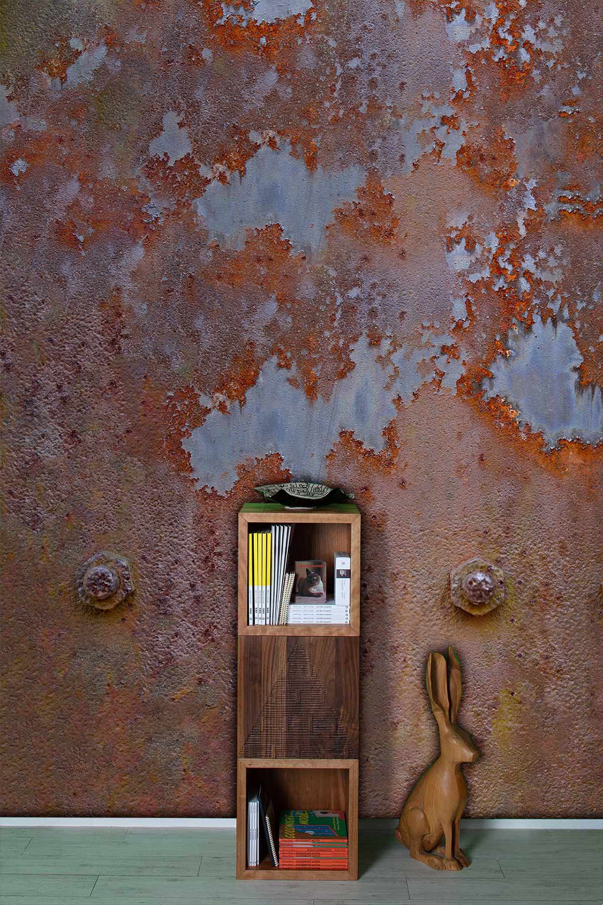 Vintage Rusted Metal Wallpaper with bookshelf, rabbit decor, and light wood flooring in modern room.