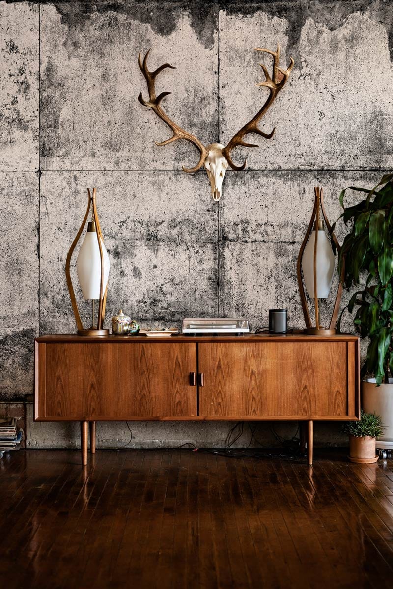 Industrial Concrete Grey Grunge Textured Mural Wallpaper, wooden sideboard, wooden flooring, antler wall decor.