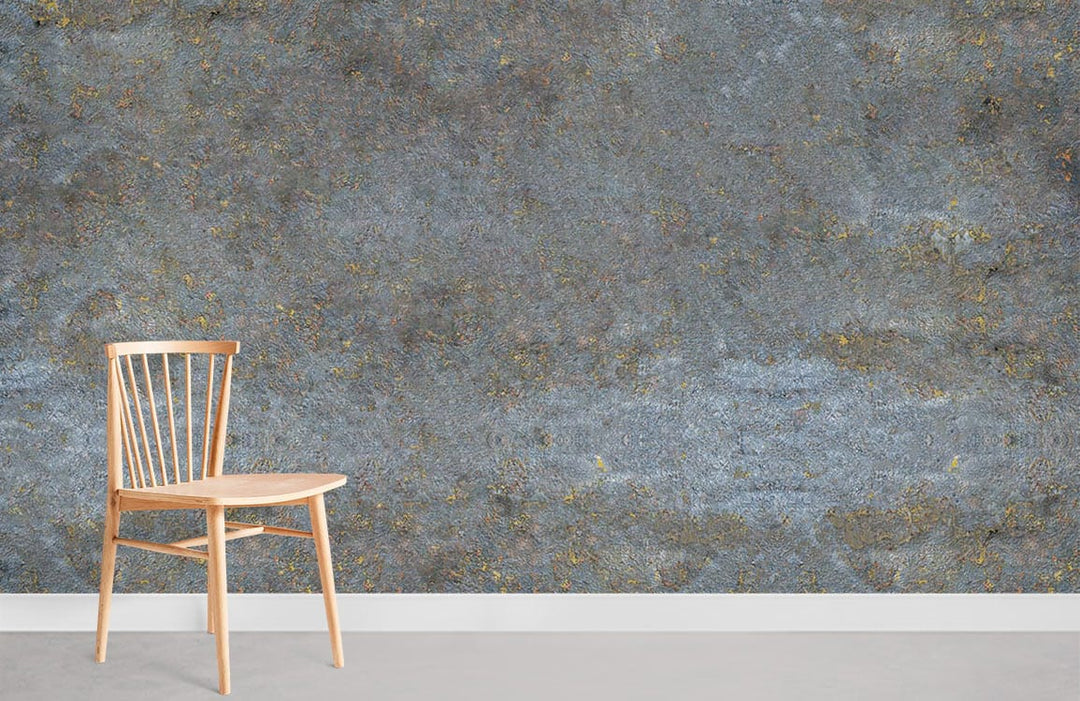 Vintage industrial blue and gold textured mural wallpaper with wooden chair on concrete flooring.