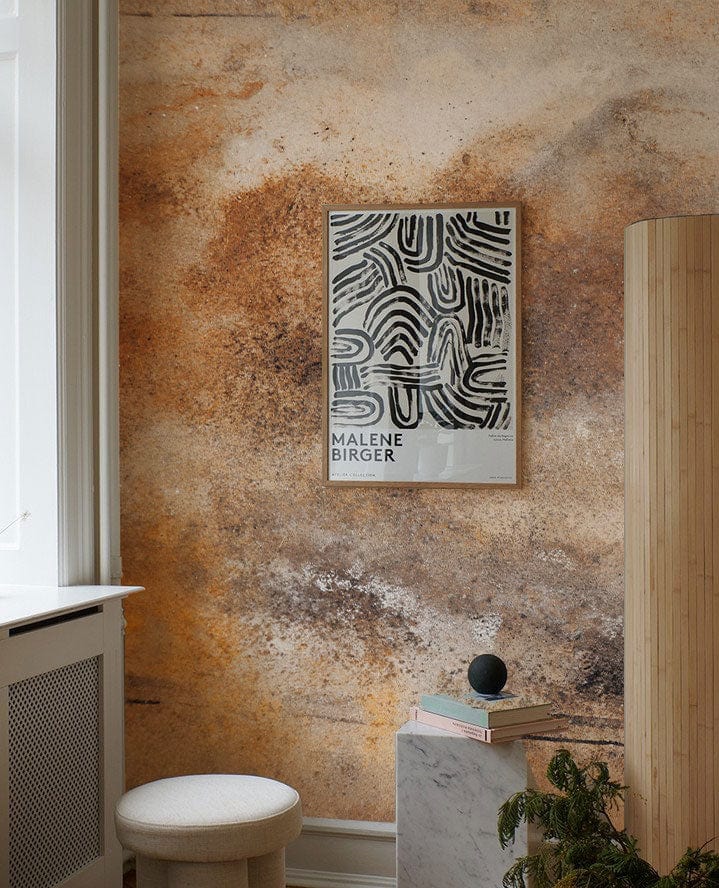 Rustic Earth Tones Abstract Art Mural Wallpaper in living room with cream stool and wooden column.
