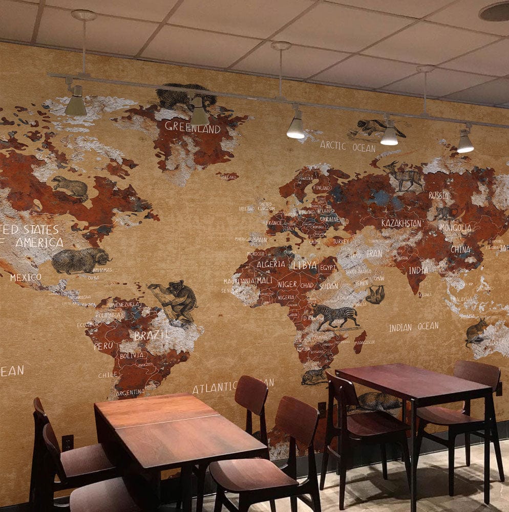 Vintage Earth Tones World Map Mural Wallpaper with Animal Illustrations, café setting, wooden tables, chairs.