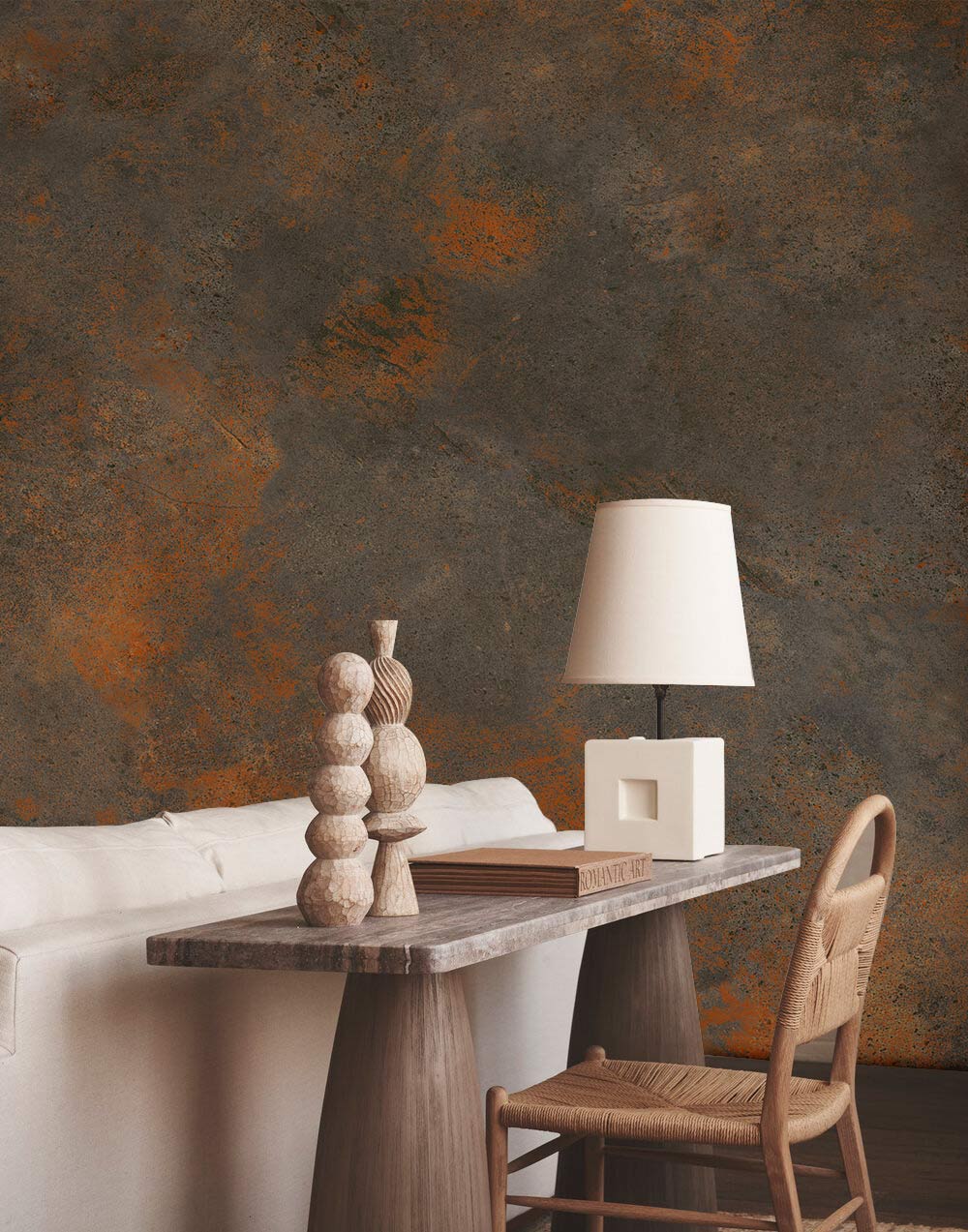 Rustic wallpaper with earthy tones behind white sofa and wooden table in living room.