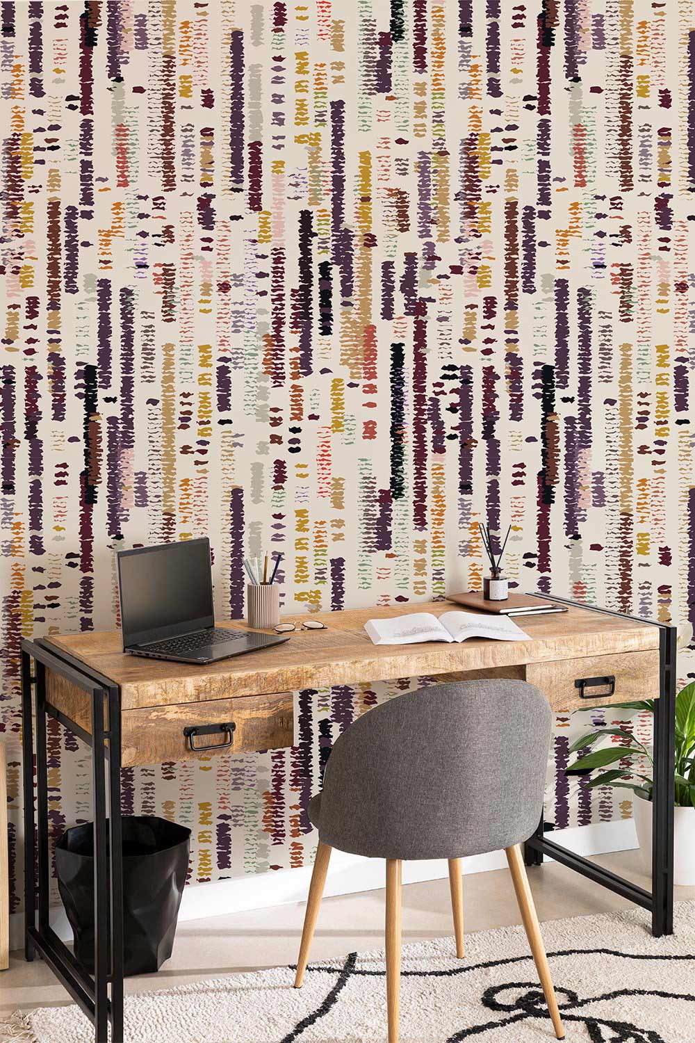 Abstract Earth Tones Vertical Lines Wallpaper, wooden desk, grey chair, modern rug, cosy study space.