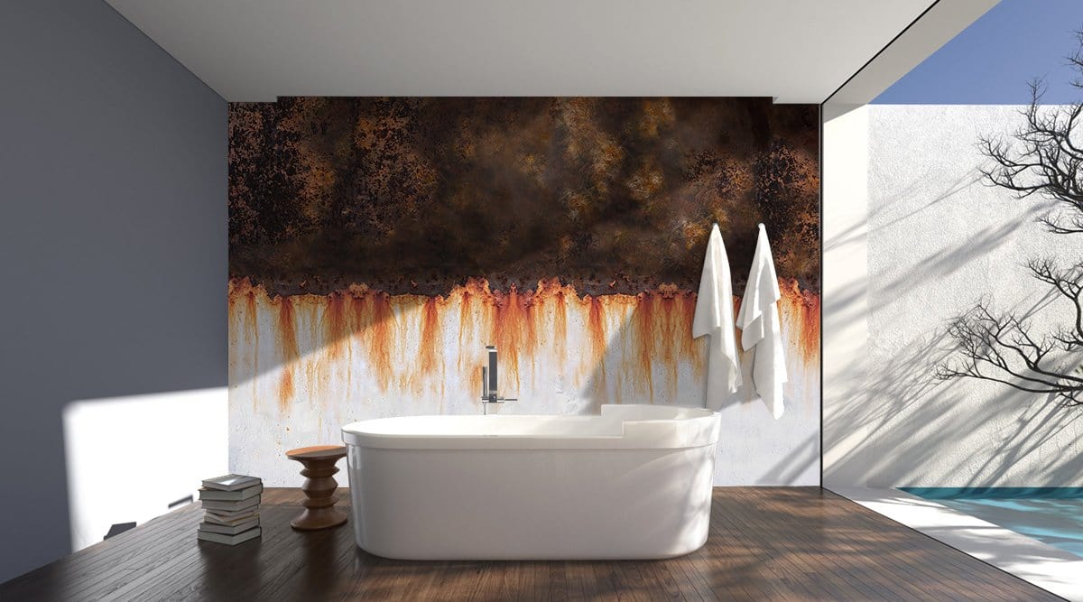 Vintage Rustic Industrial Rust Texture Mural Wallpaper in earthy tones; bathroom with white freestanding tub.