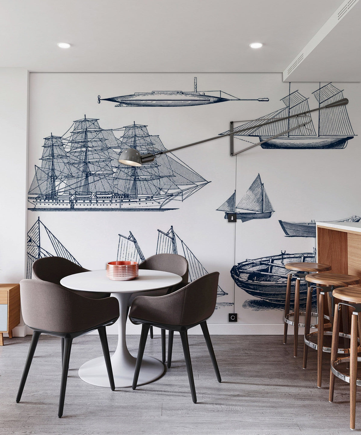 Dining room with Vintage Nautical Ships Wallpaper, modern round table, grey chairs, wood bar stools.