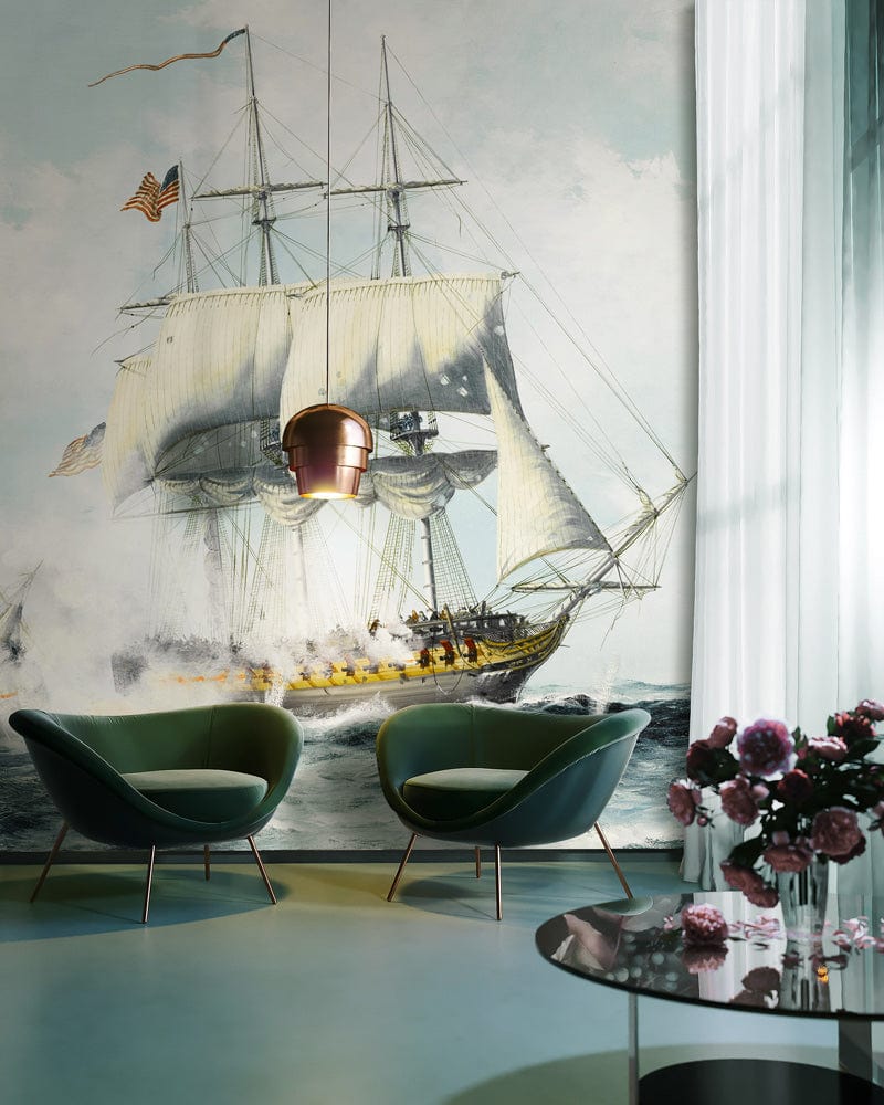 Vintage Seafaring mural in pastel hues, featuring two green armchairs, maritime style, elegant decor.