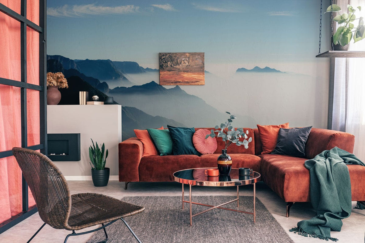 Tranquil Blue Mountain mural wallpaper, orange sofa, modern living room, neutral flooring, nature decor.