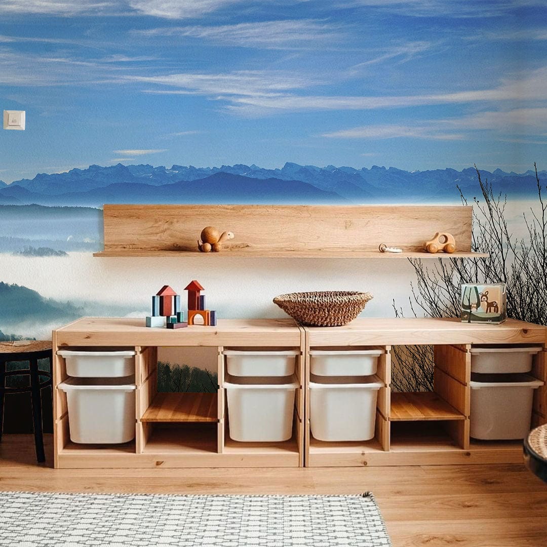 Serene Mountain Mist Wallpaper, Calming Blue; wooden storage unit, light wood flooring, kids' playroom setting.