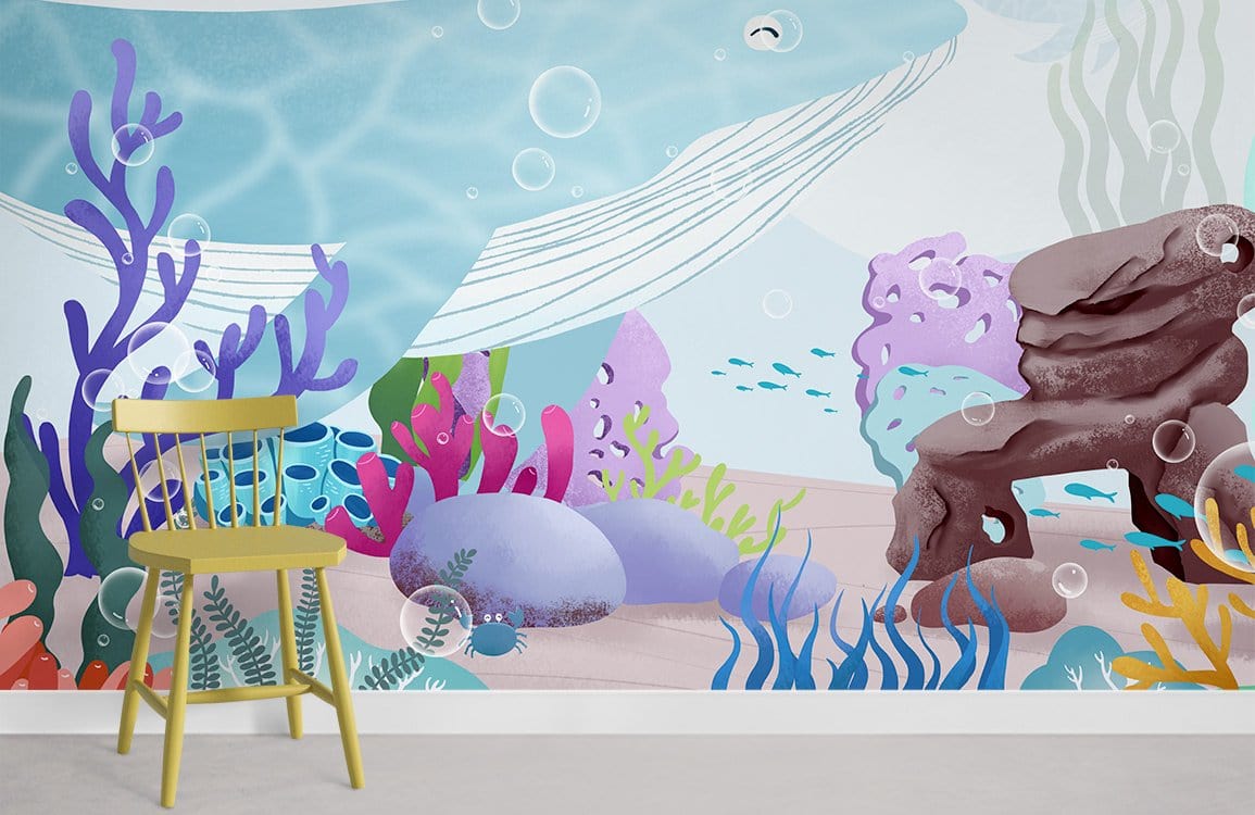 Underwater mural with blue whale, coral; wooden chair, light flooring, playful children's room decor.