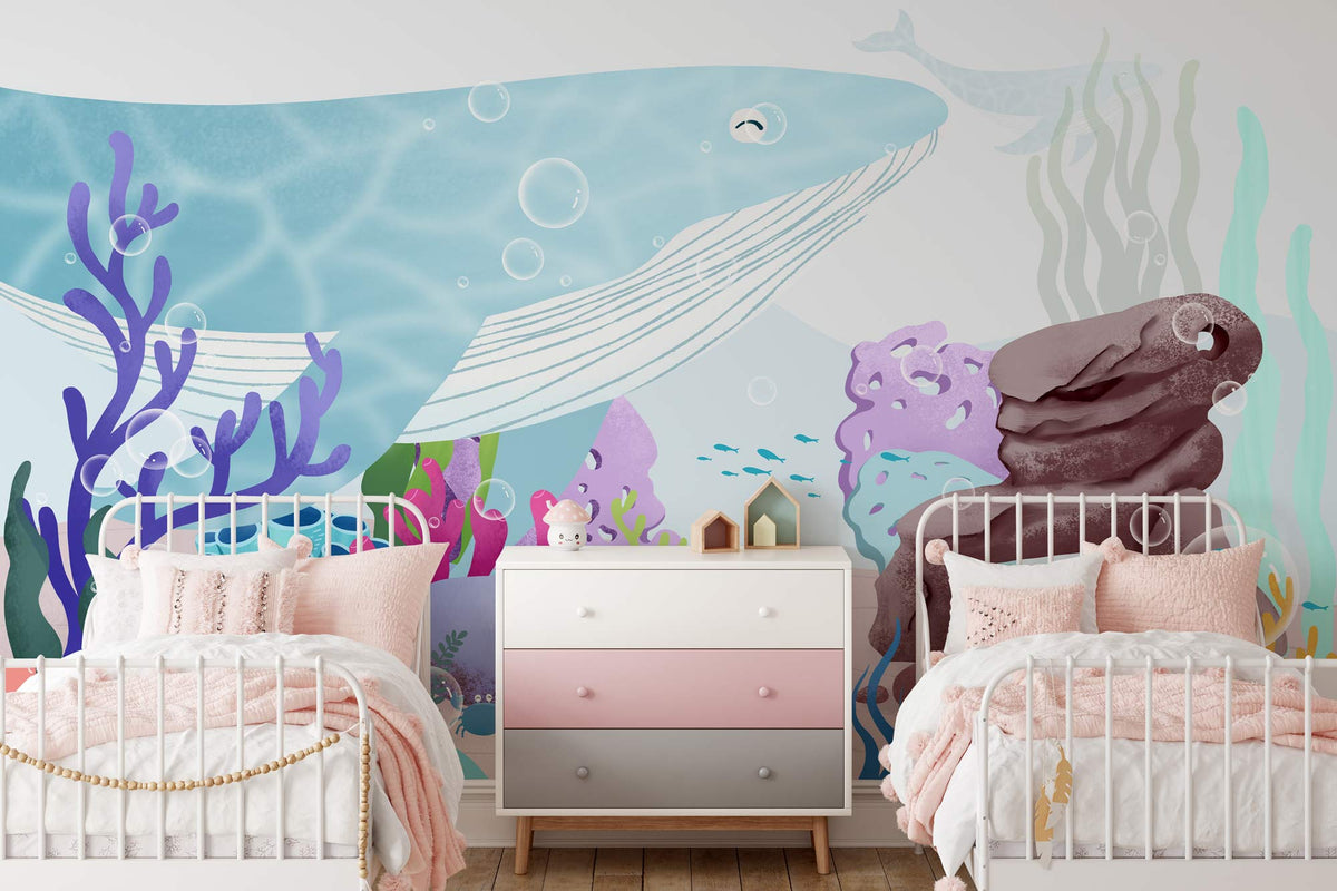 Underwater Adventure Mural Wallpaper; blue whale, coral, children's room, twin beds, pink accents, wooden flooring.