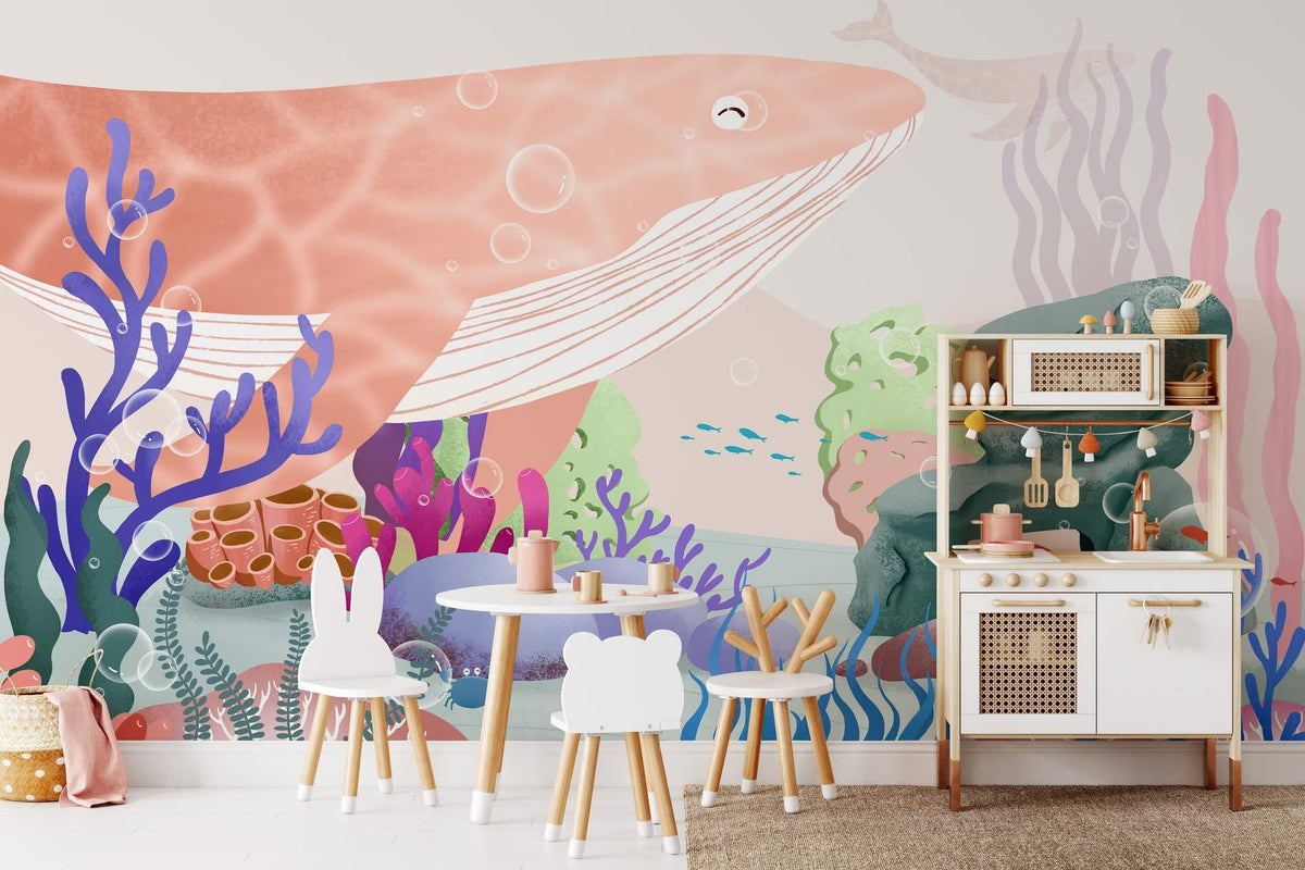 Children's room with vibrant underwater mural wallpaper, coral, whale design, white furniture, soft beige floor.