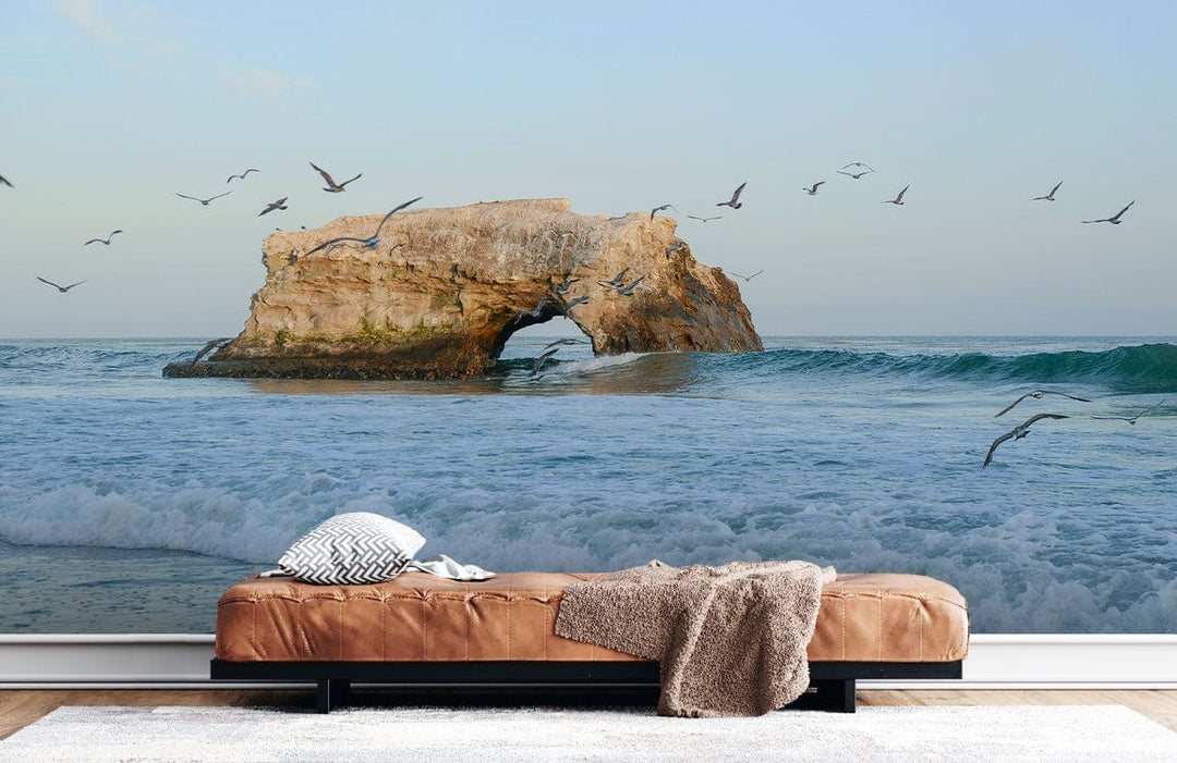 Serene Coastal Seascape Mural Wallpaper, cosy tan sofa, wooden flooring, relaxing ocean room ambience.