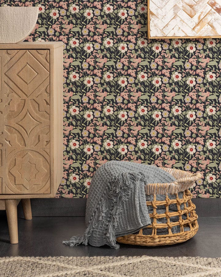 Vintage floral wallpaper in soft pink and green, wicker basket, ornate cabinet, modern room design.