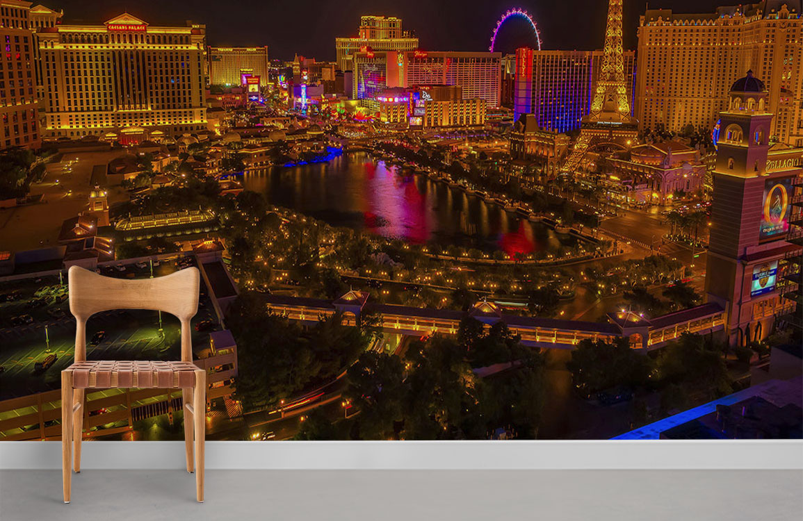 Chair complements vibrant Las Vegas cityscape mural wallpaper on neutral flooring, showcasing dazzling night-time lights.