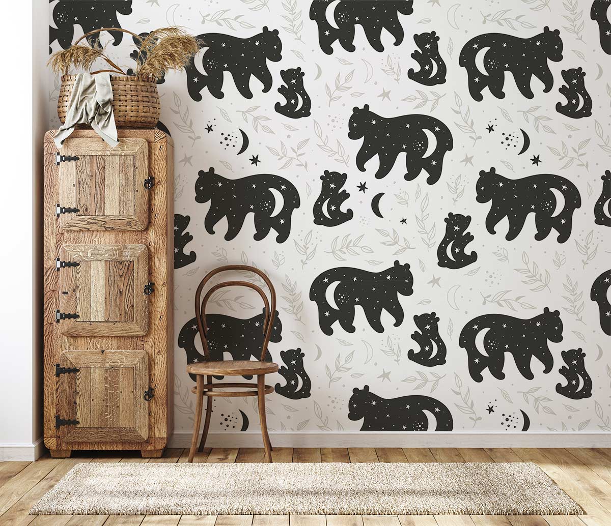 Monochrome woodland bear mural wallpaper with wooden cabinet, chair, rug, and hardwood floor in room setting.