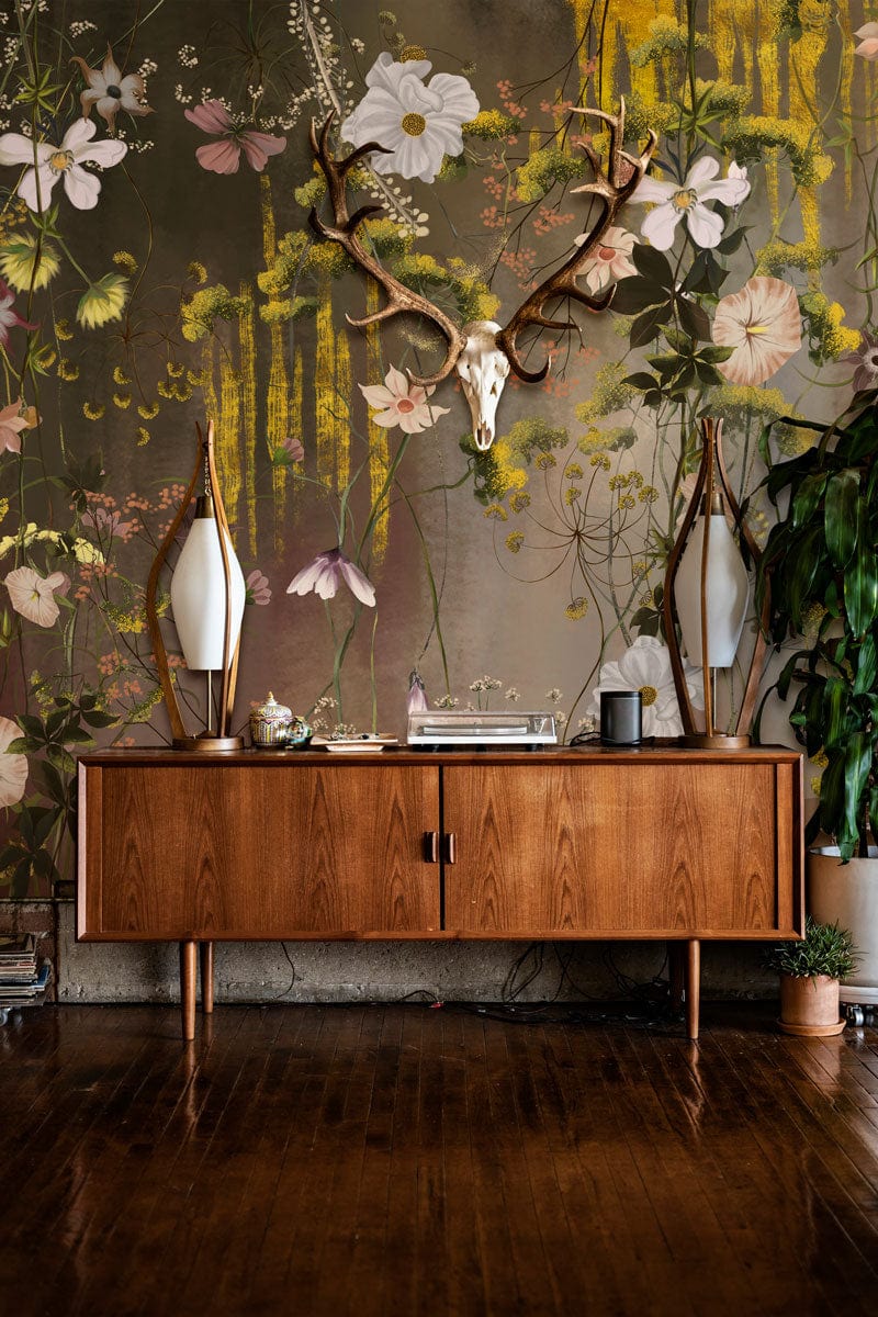Whimsical Floral Dreamscape mural wallpaper with vintage botanical elegance, mid-century sideboard, and hardwood flooring.