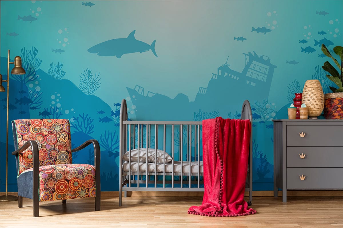 Underwater Ocean Adventure Mural - Shipwreck; nursery with colourful armchair, grey cot.