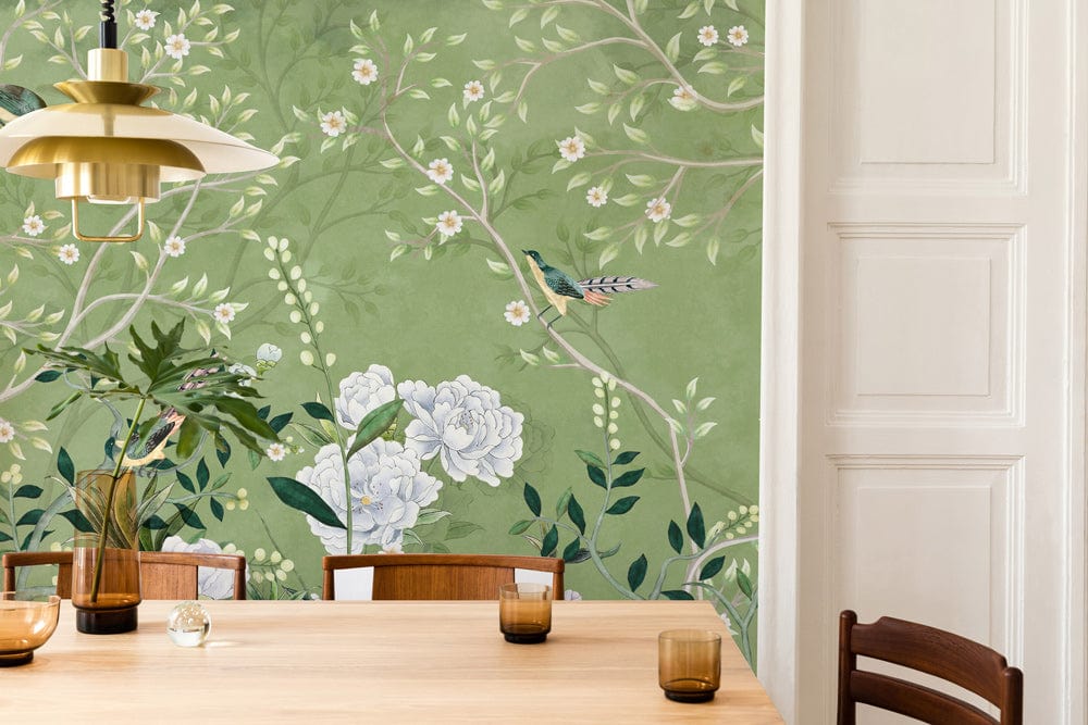Elegant green floral and bird mural wallpaper, traditional dining room, wooden table, white wall panel.