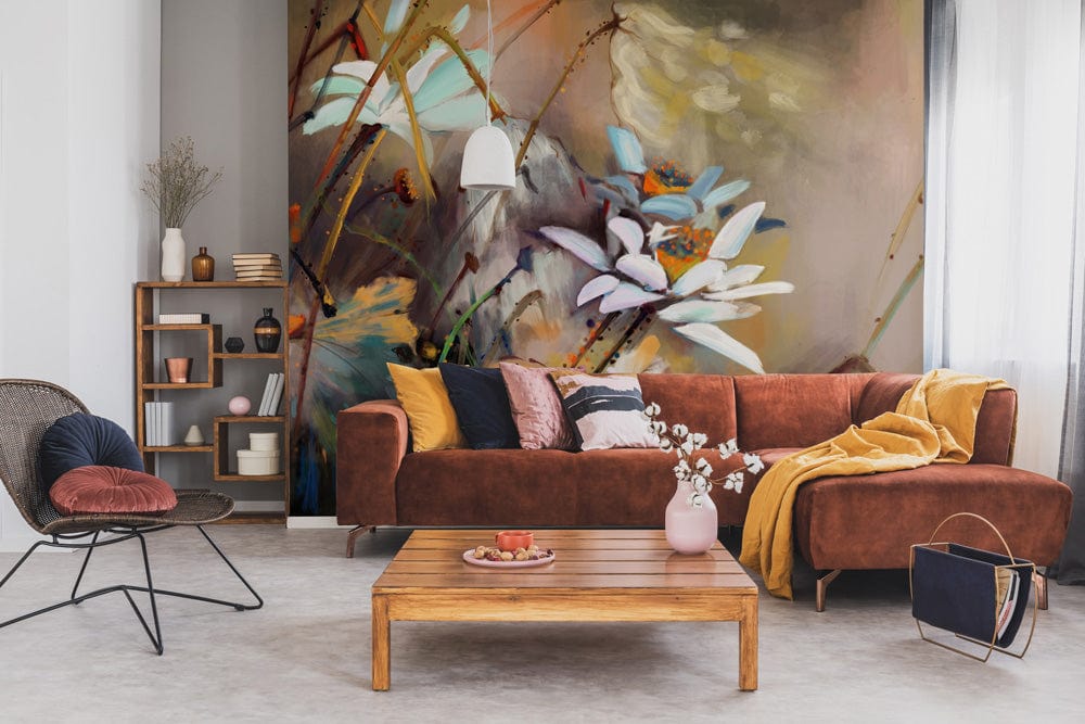 Elegant floral mural wallpaper with daisies, earthy tones, brown sofa, pendant lamp, wooden shelving.