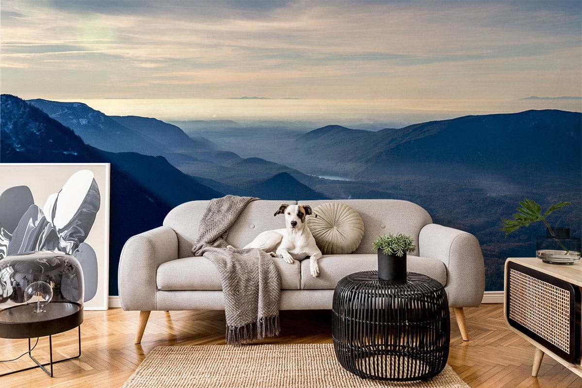 Tranquil Mountain Vista mural wallpaper with grey sofa, black coffee table, wooden flooring in living room.