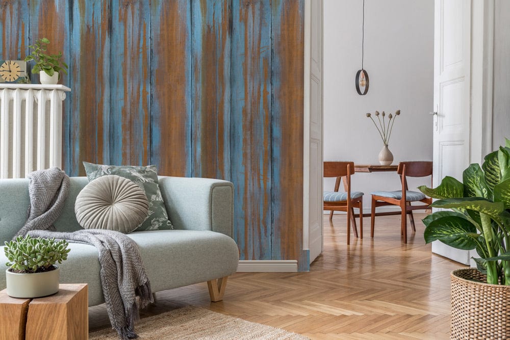 Rustic copper and blue wallpaper with vintage look, light grey sofa, wooden flooring, modern decor.