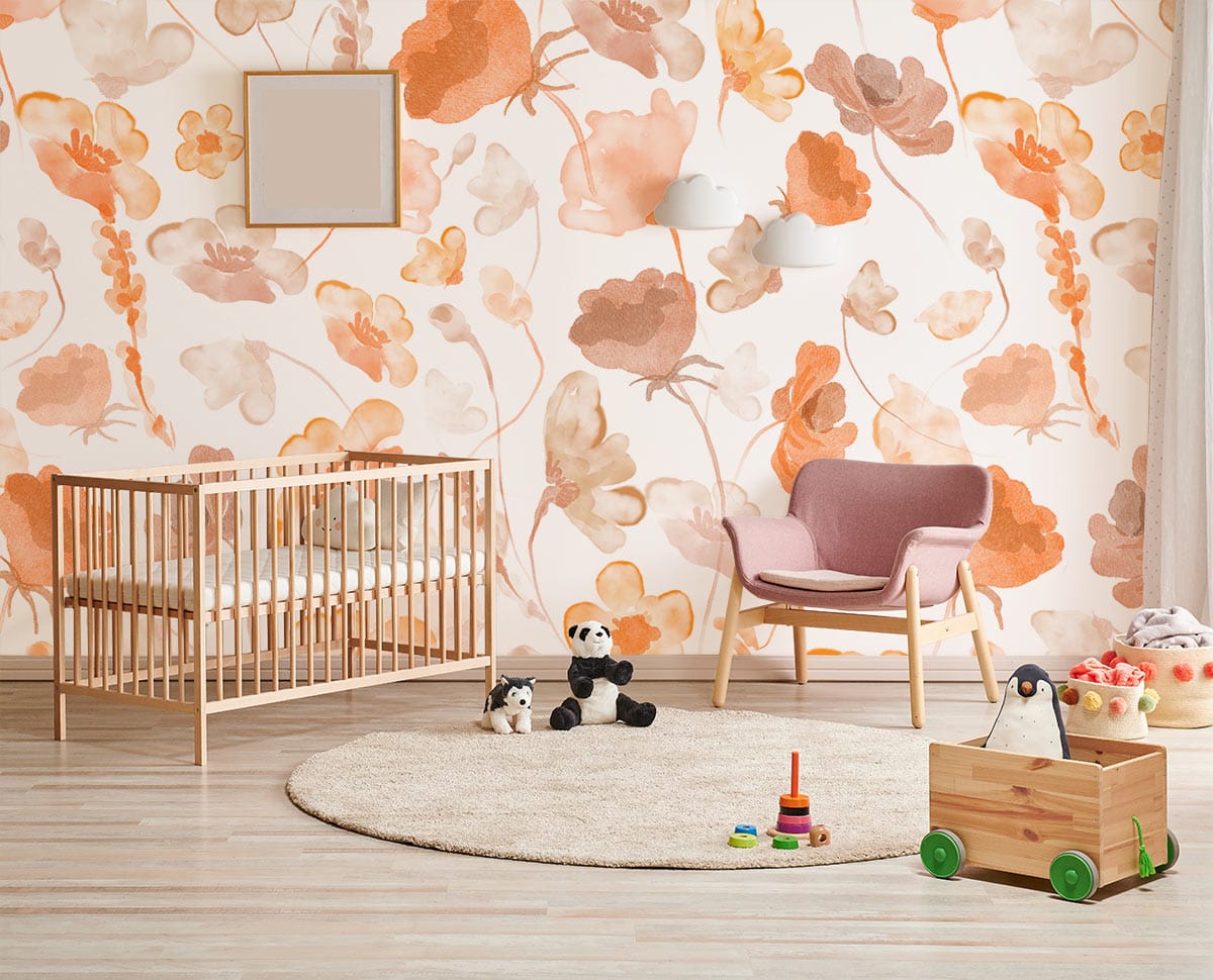 Soft Autumn Floral Watercolour Wallpaper in nursery, wooden cot, pink chair, light wood flooring.