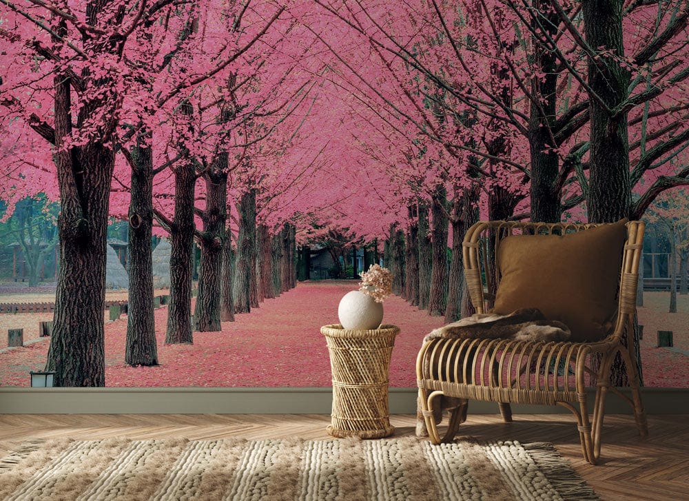 Blossom Avenue Mural Wallpaper with pink cherry trees; features wicker chair, patterned rug, neutral decor.