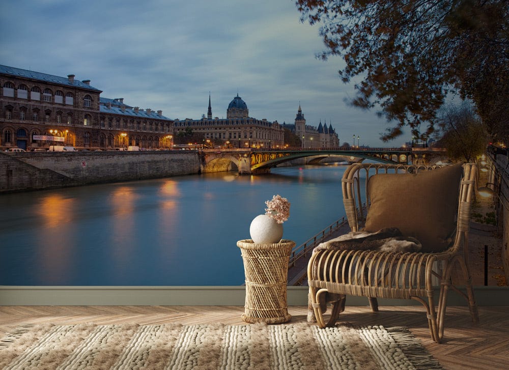 Elegant Paris mural wallpaper in evening blues, featuring wicker chair, woven rug, and wood flooring.
