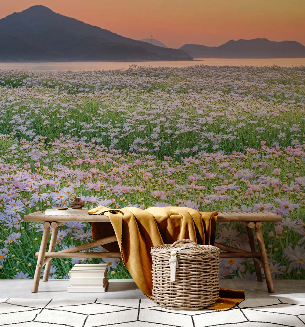 Serene Pastel Sunset Daisies Mural Wallpaper in living room with wooden bench and geometric flooring.