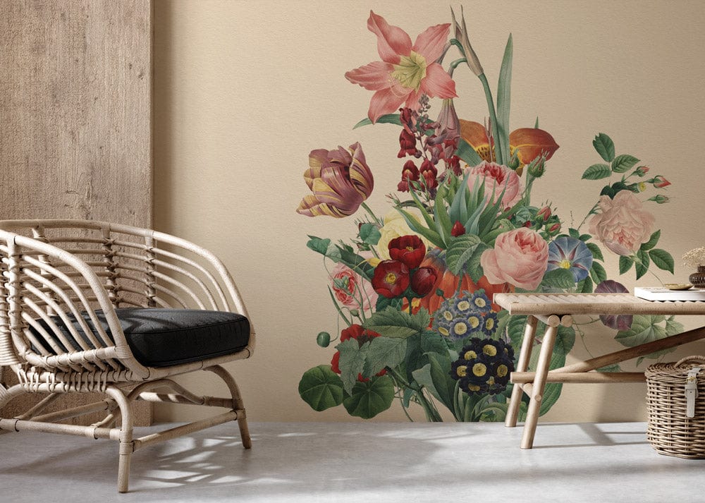 Vintage botanical floral mural wallpaper with pastel blooms; rattan chair, cream wall, light wooden floor.