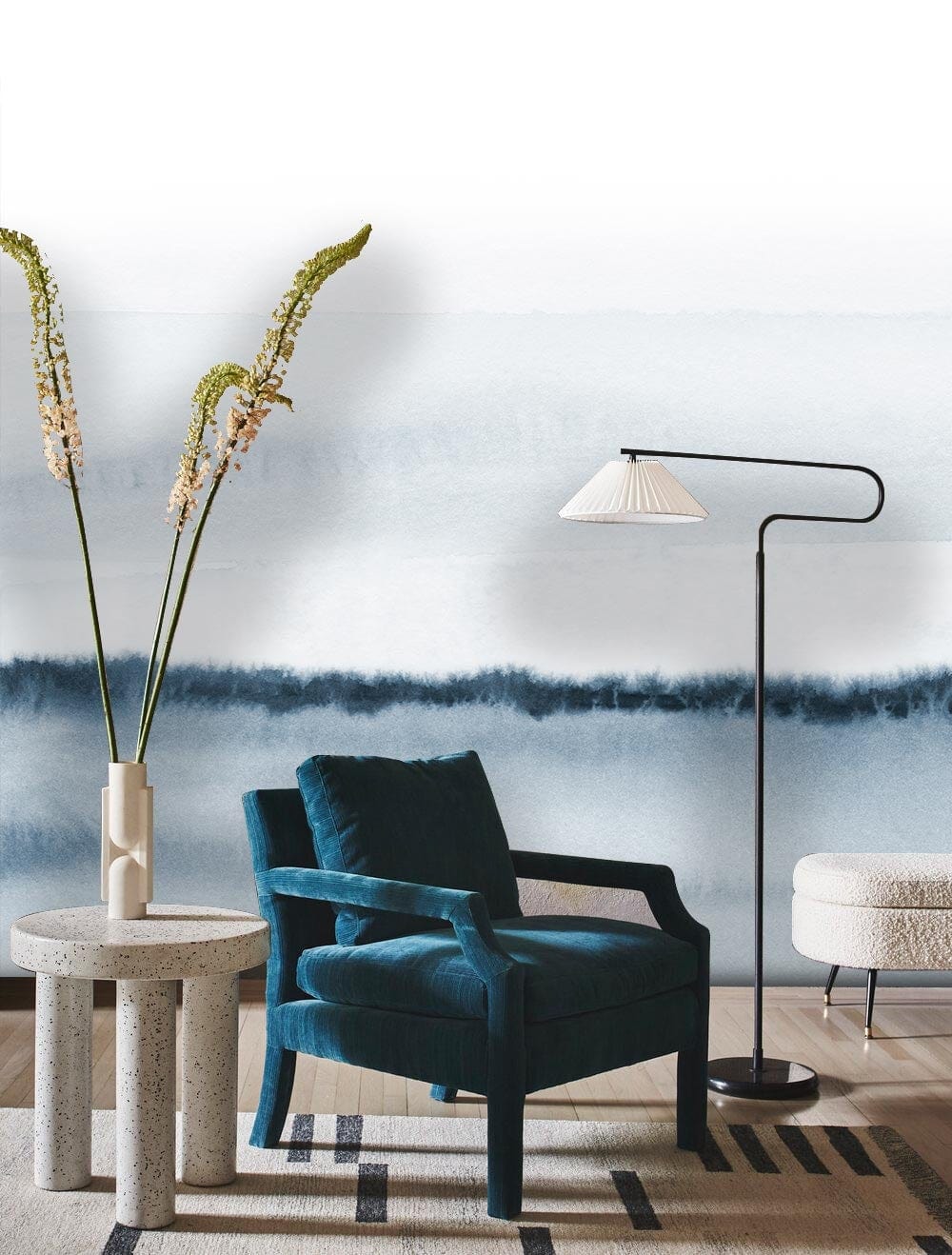 Chic modern interior with Serene Blue Watercolour Mural Wallpaper, teal velvet armchair, and floor lamp.