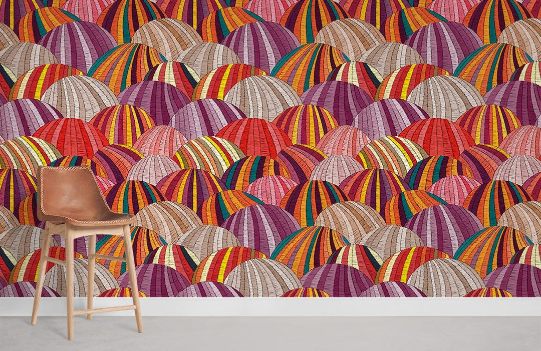 Vibrant geometric mural wallpaper with multi-coloured domes, modern wall design featuring brown leather chair.
