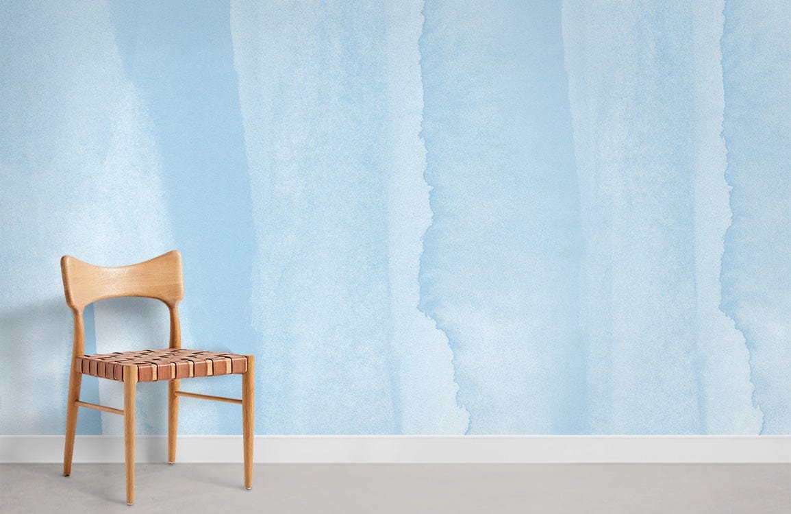 Soft Blue Watercolour Stripes Wallpaper, wooden chair, tranquil pastel decor, grey flooring, serene room setting.