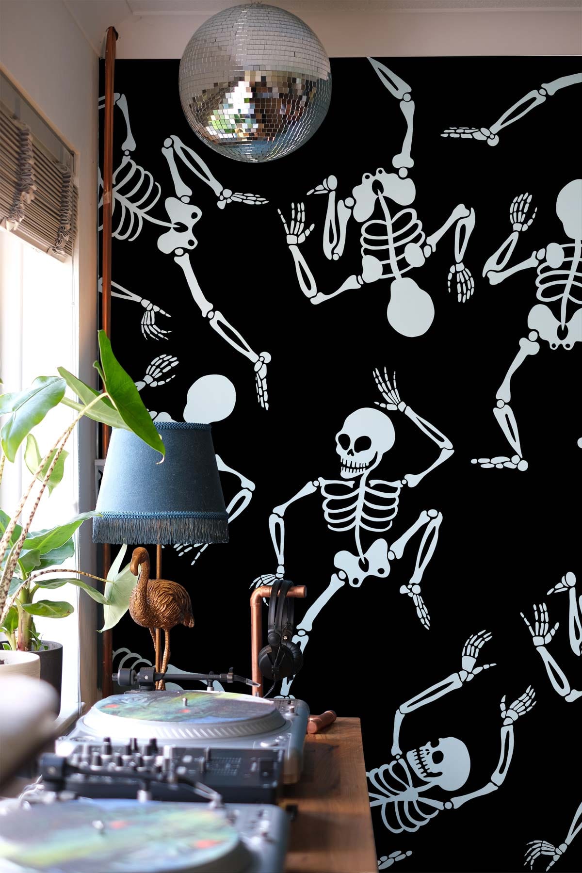 Dancing Skeleton Black and White Wallpaper behind turntables; room includes disco ball, green plant.